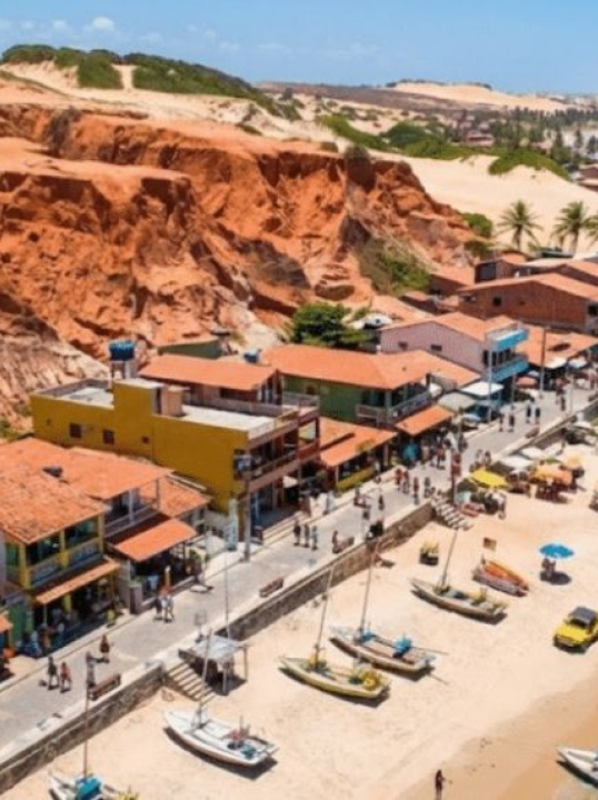 Uma vila pouco conhecida no Nordeste atrai turistas e investidores com falésias vermelhas e ventos ideais para energia limpa